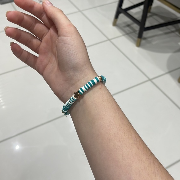 A beautiful blue and white bracelet with gold star and circle beads. Stretchy. - Picture 3 of 3